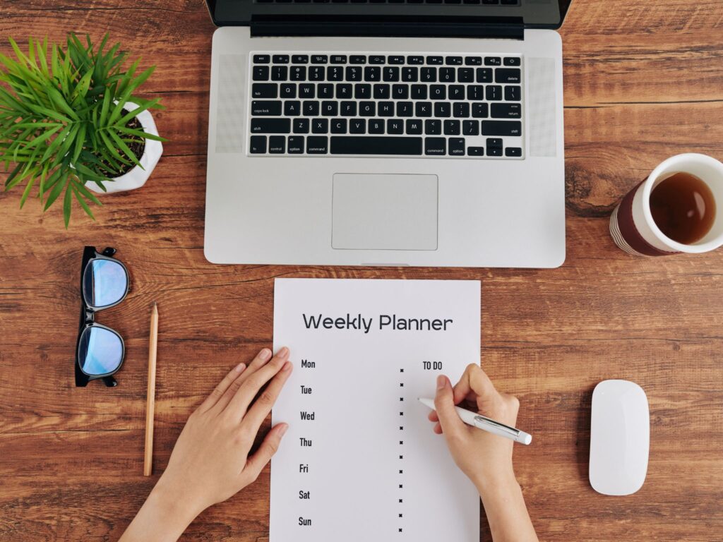 A person monitoring her Bundaberg business, adjusting her weekly planner.