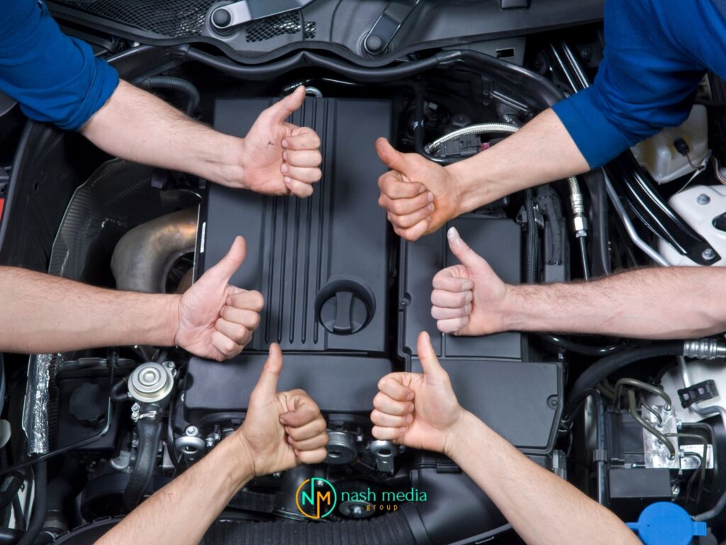 Team of tradies giving thumbs up over a car engine for lead generation for modern tradies in Bundaberg