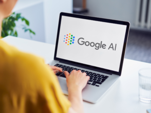 Person using a laptop showing Google AI interface, representing AI reading customer reviews for businesses.