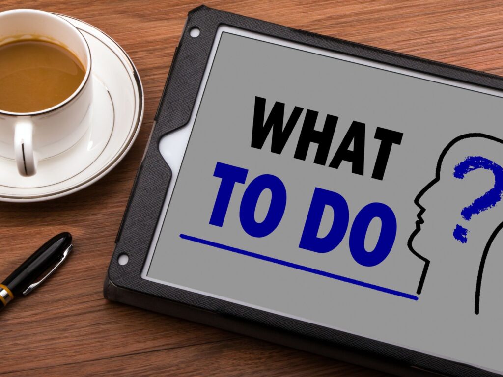 A coffee cup on the table and a tablet showing "What to do?" text.